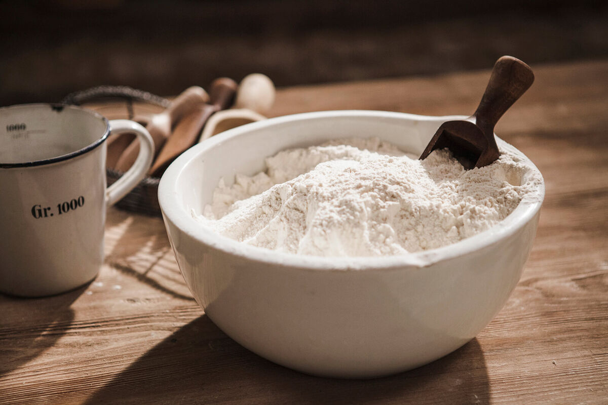 Close up of bowl of flour with scoop