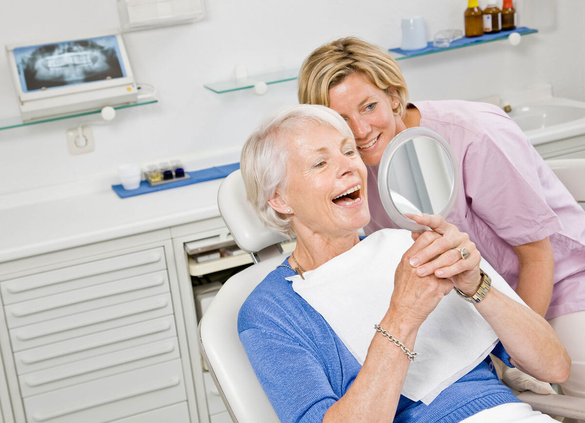 Dental patient looking at dentures