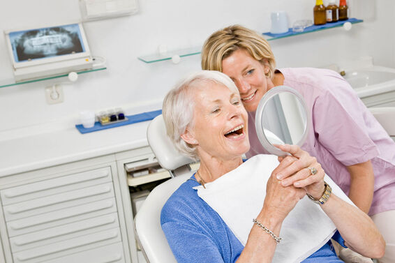 Dental patient looking at dentures