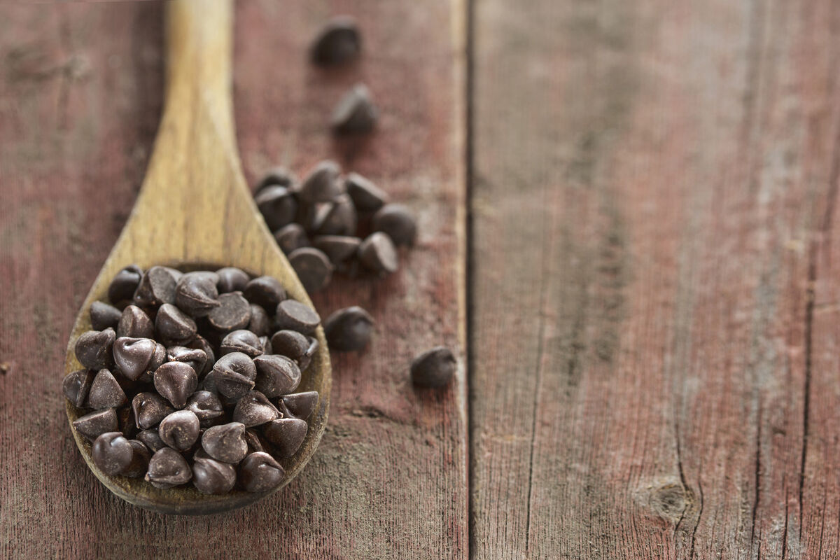 Chocolate chips in wooden spoon