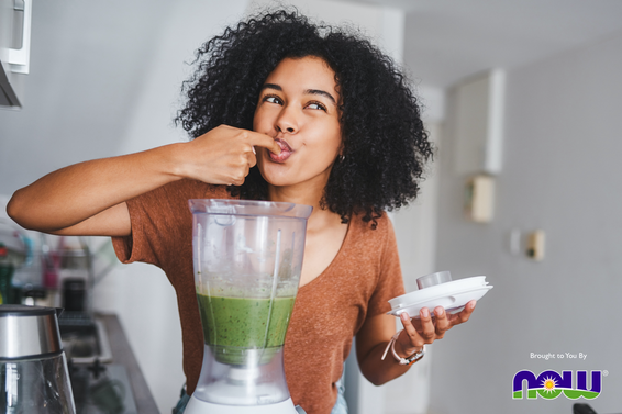 Woman making a green smoothie