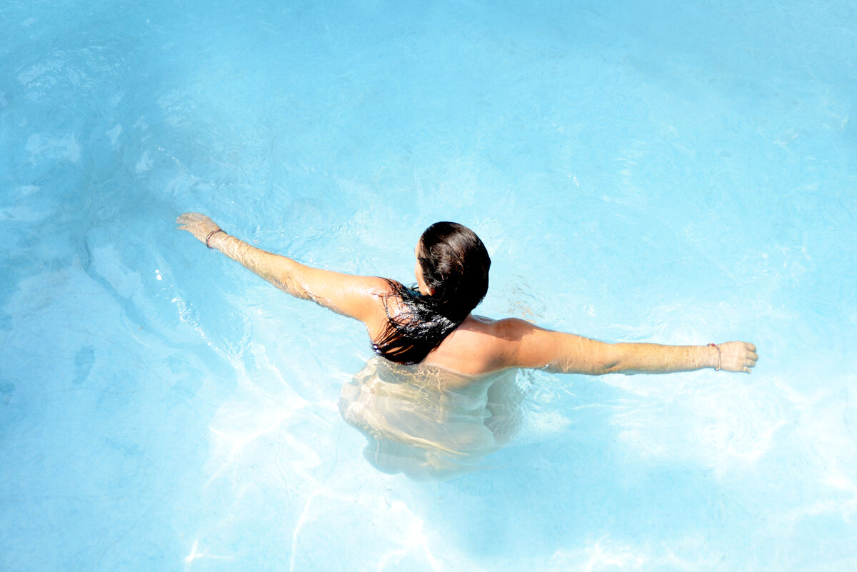 Naked woman in a swimming pool