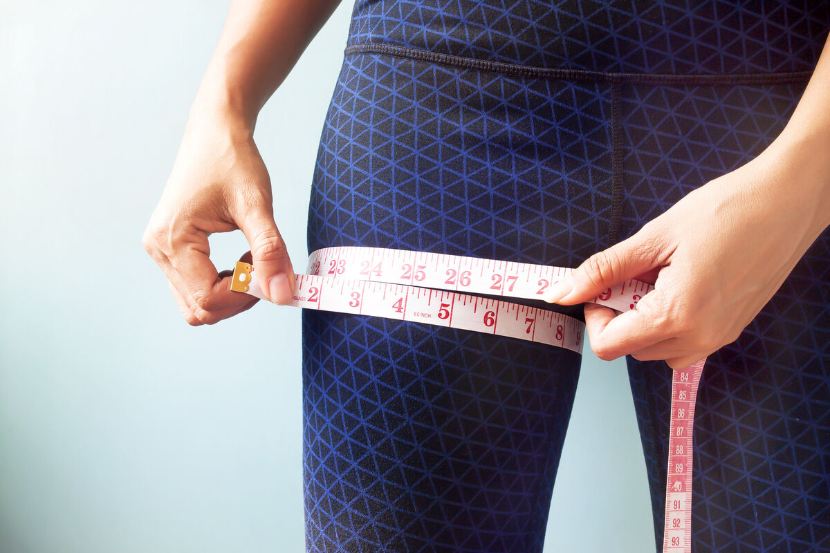 Woman Measuring Her Thigh