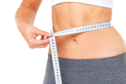 Woman measuring waist with a tape measure