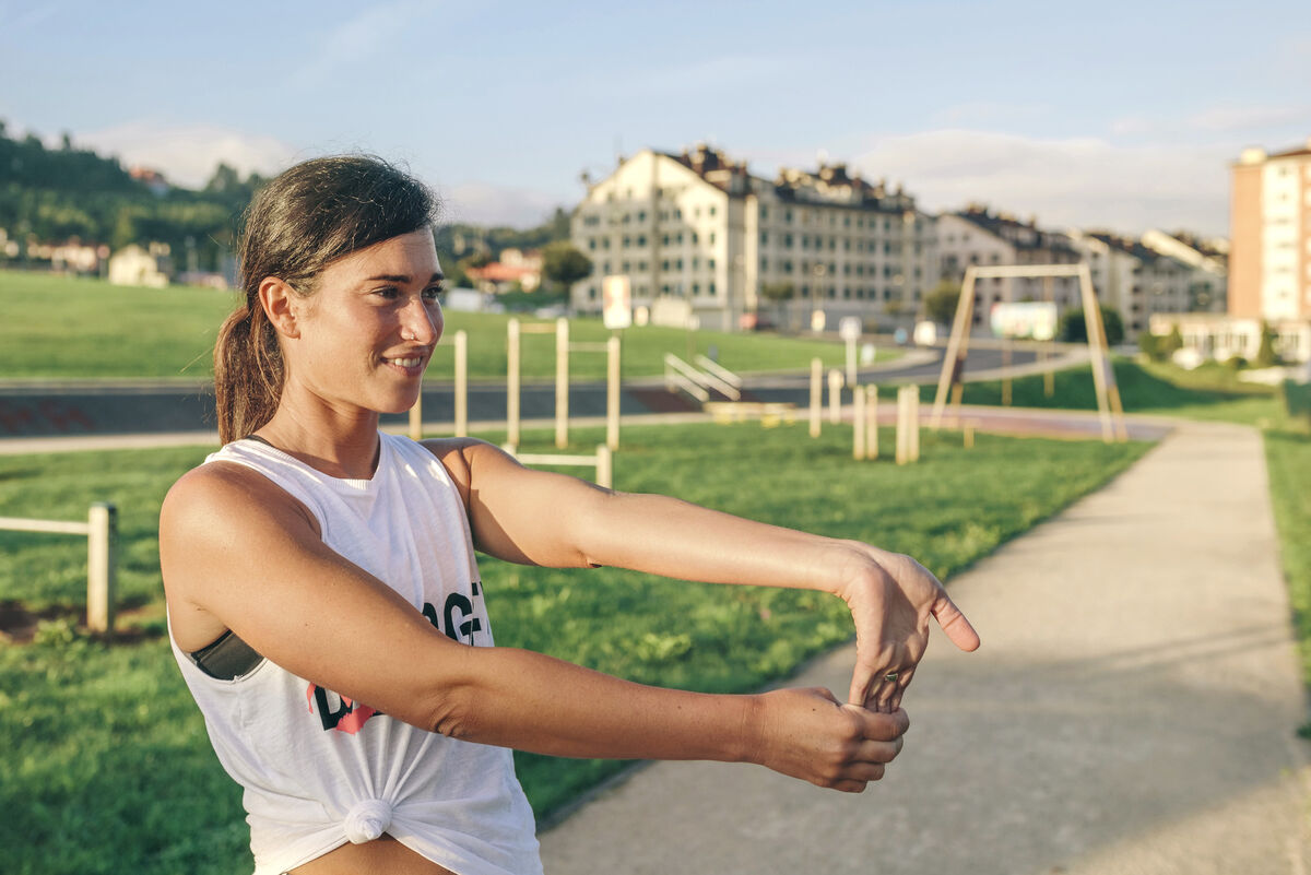 Woman stretching wrist at park