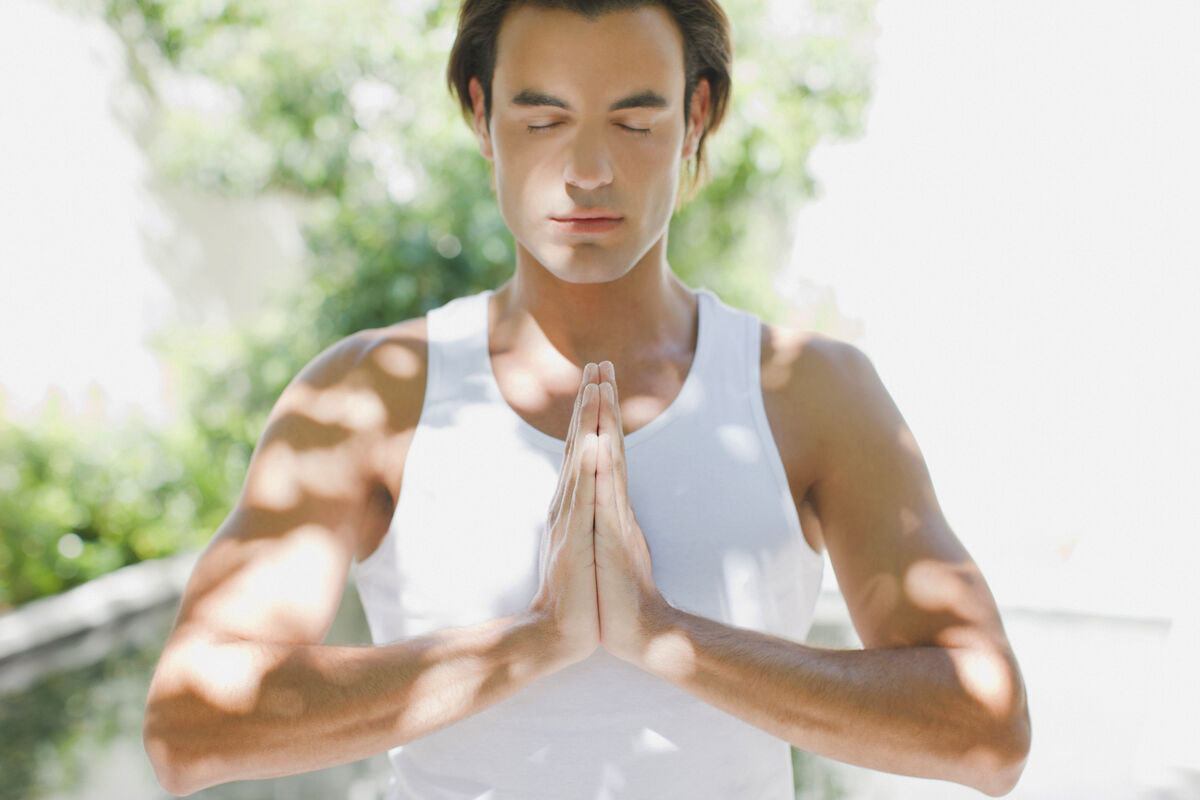 Man standing with hands clasped