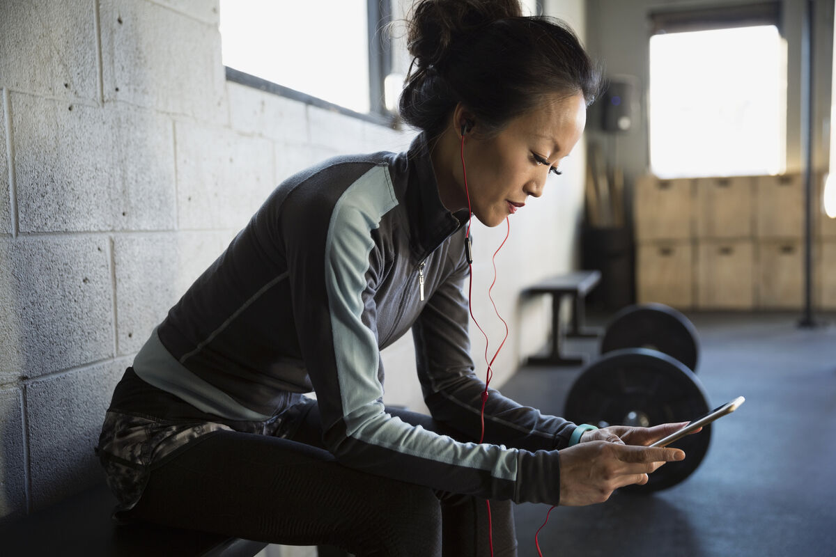 woman with phone at gym
