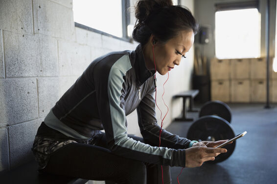 woman with phone at gym