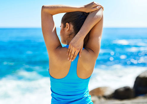 Woman stretching at beach