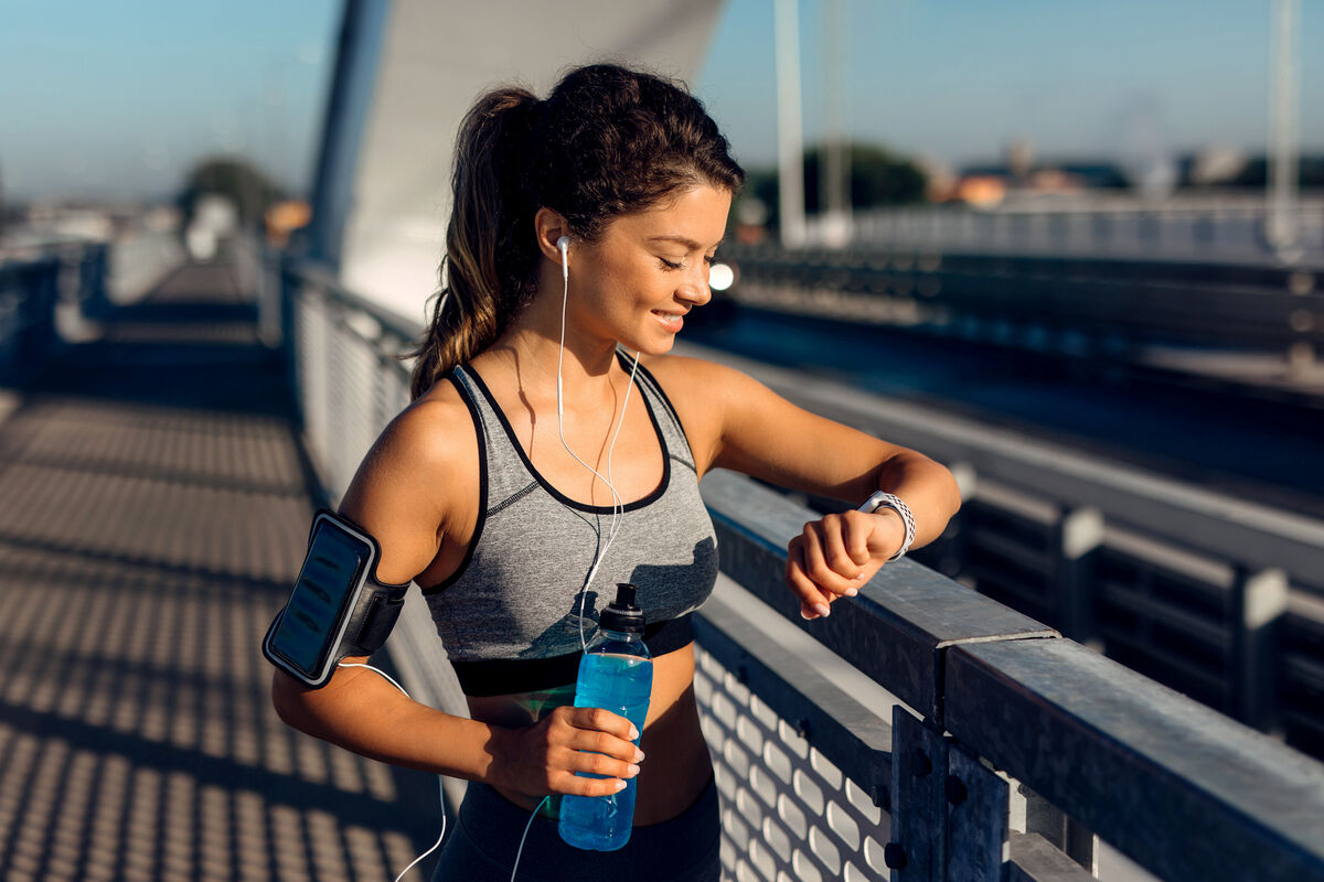 Female runner checking info on smart watch