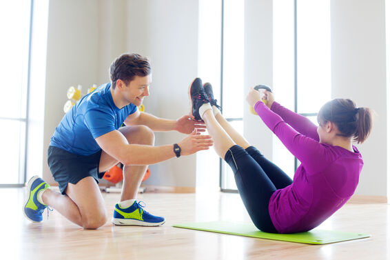 Personal trainer working with woman