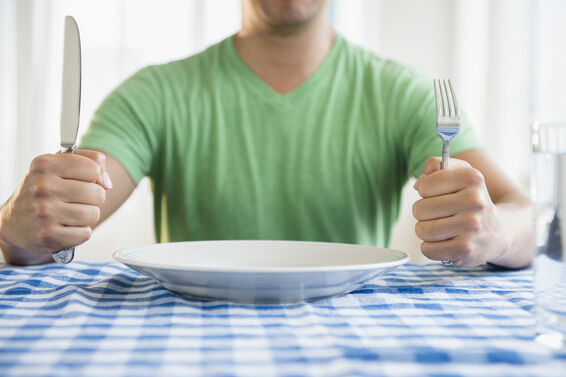 man holding fork and knife