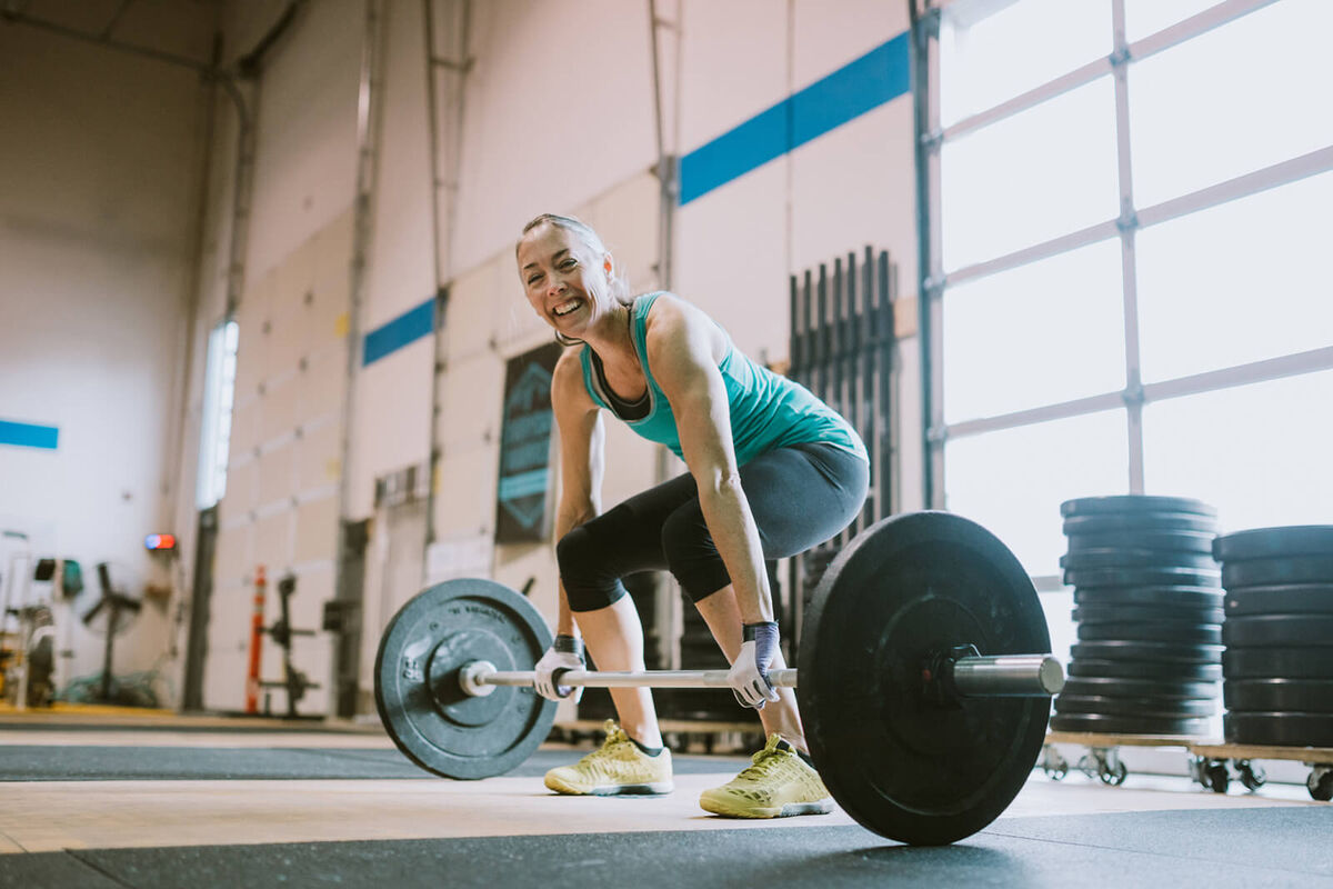 Woman Practicing Deadlifts in Cross Training Gym