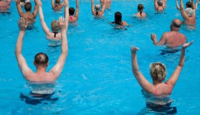 group of seniors stretching in water. source: istockphoto; permission: licensed