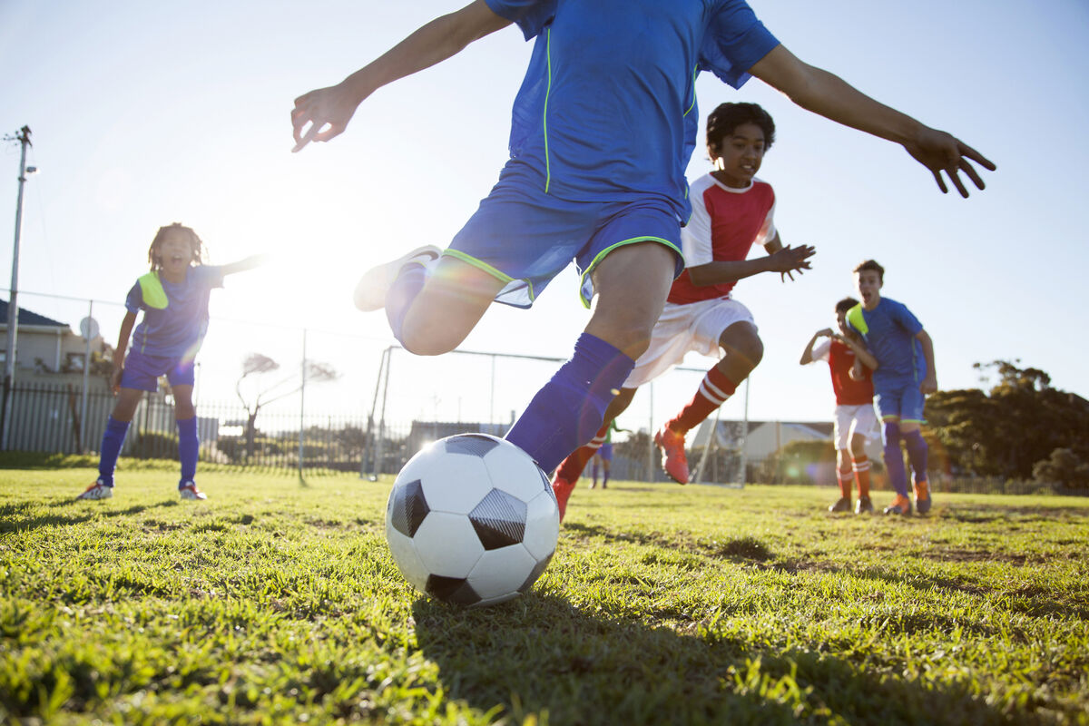 Boy kicking soccer ball