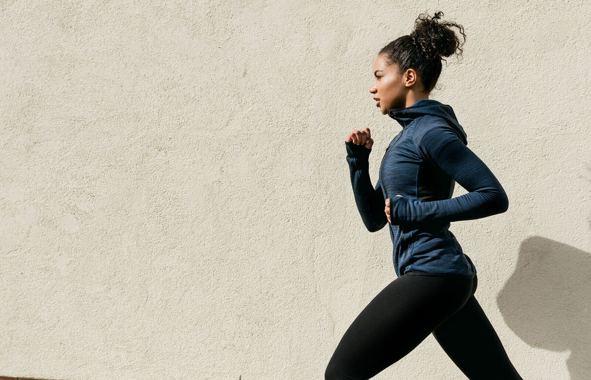 Woman Running Against Wall