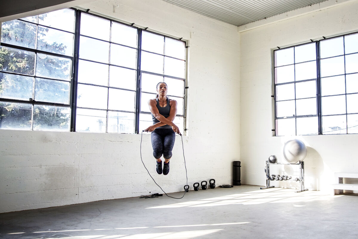 Female athlete doing criss cross jumps