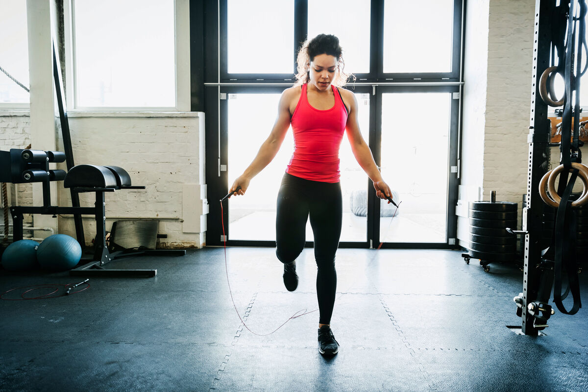 Young Woman Using Skipping Rope To Keep Fit