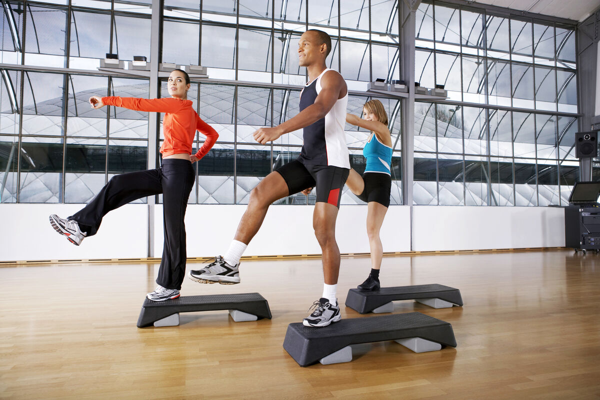 People doing step aerobics