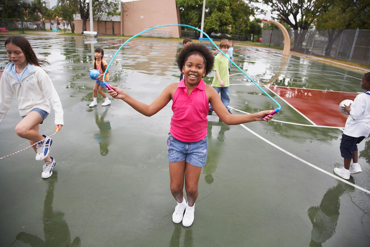 Girl jumping rope on playground