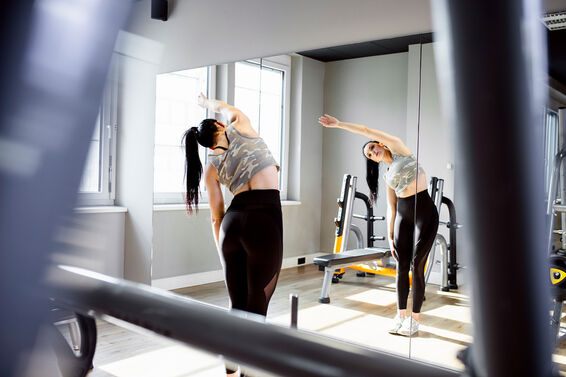 Woman stretching in front of mirror