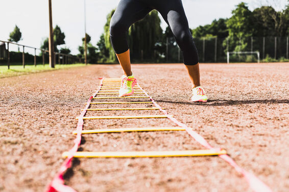 Woman exercising with agility ladder