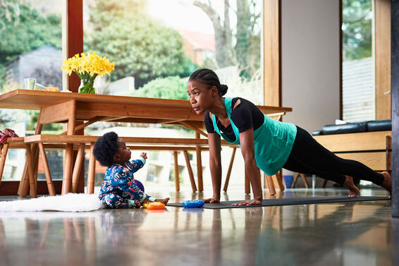 Baby boy assisting mother exercising