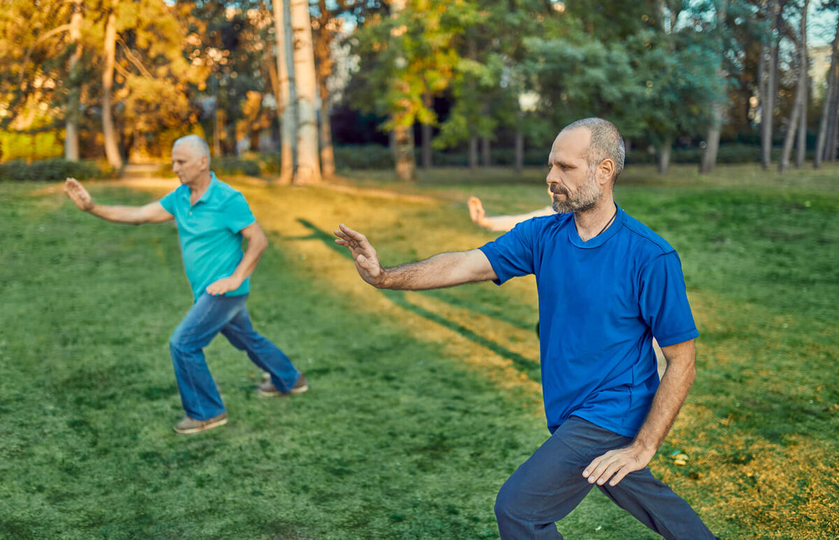 Group of people doing Tai chi in a park