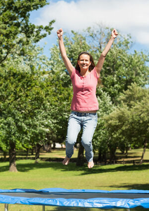 Woman jumping on trampoline