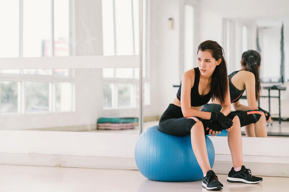 Woman on fitness ball at gym