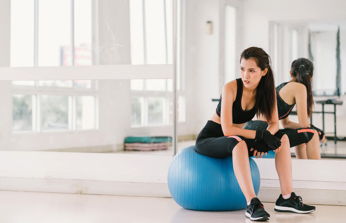 Woman on fitness ball at gym