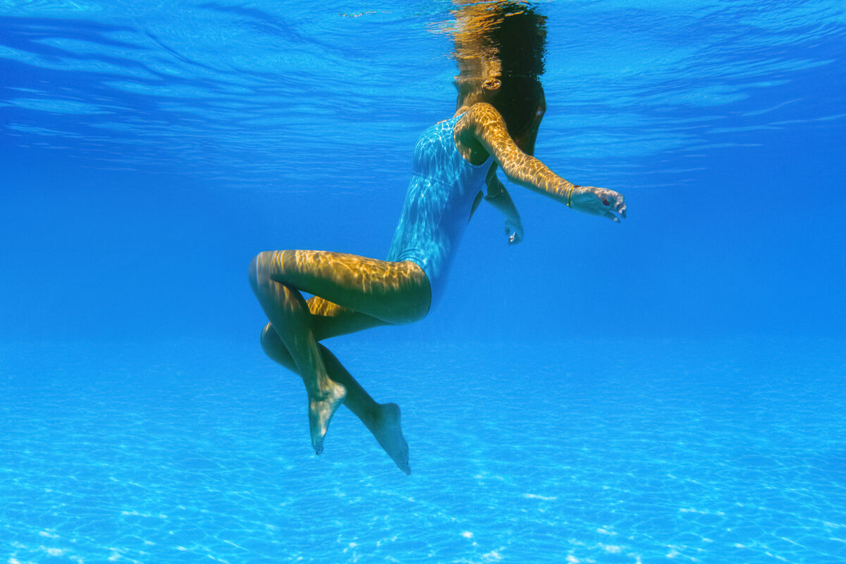 Underwater photo of a young girl refreshing and relaxing