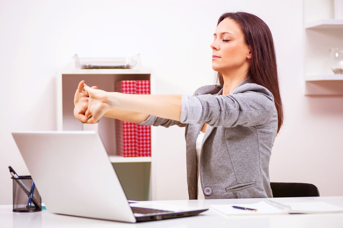 Woman in office streching