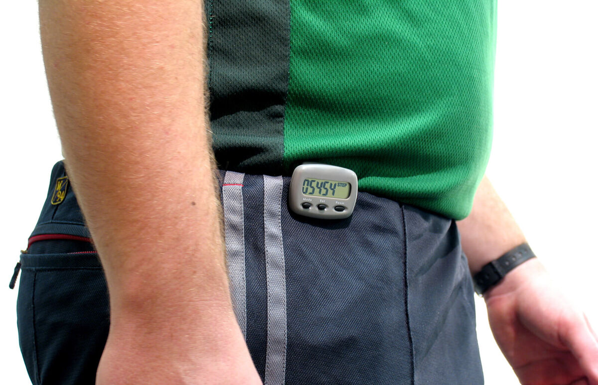 Man waist with a pedometer on pants