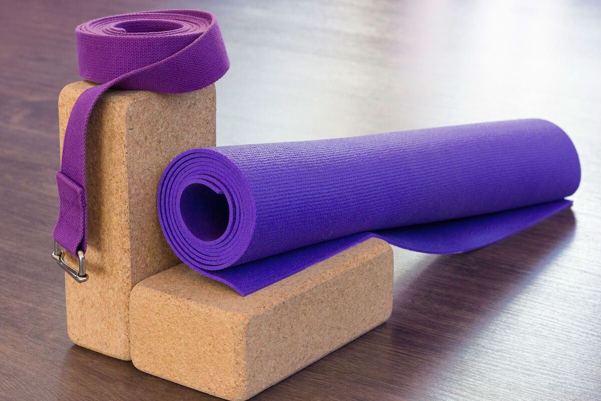 Purple mat leaning on cork bricks and cotton strap on top