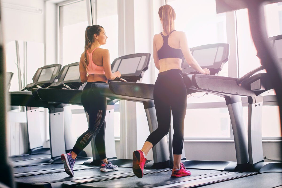 Girls exercising in the gym using a treadmill