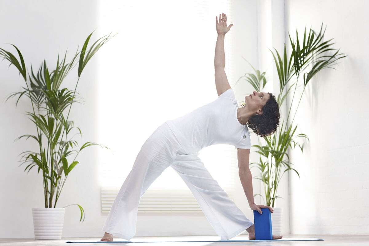 Woman exercising with yoga block