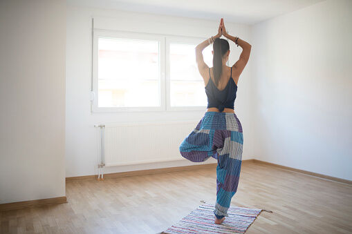 woman doing tree yoga pose