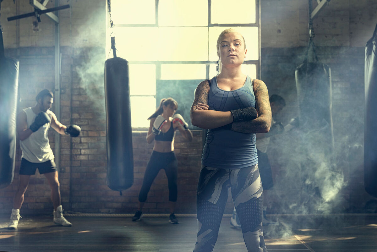 Confident woman standing in gym