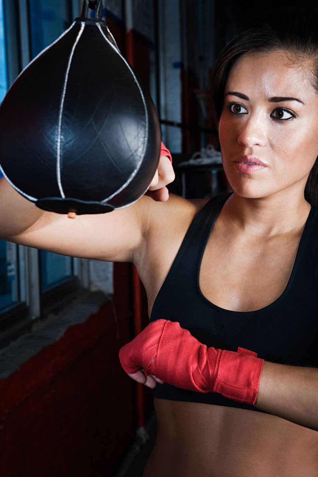 Female boxer using speed bag