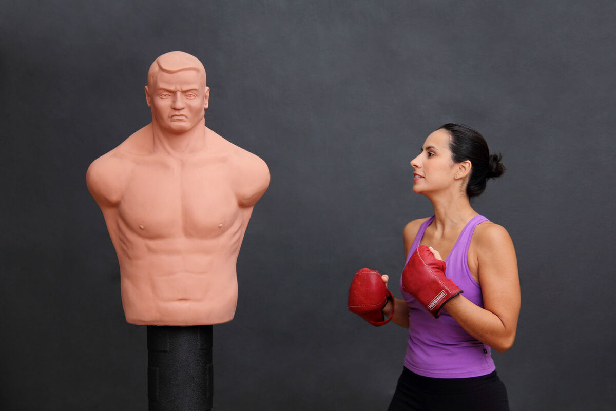 Woman ready to punch dummy bag