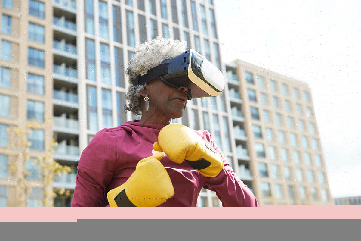 Senior woman wearing virtual reality headset while exercising in park