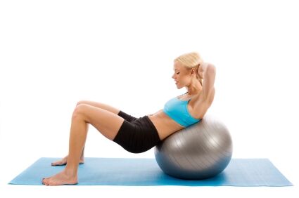 Woman doing crunches with an exercise ball.