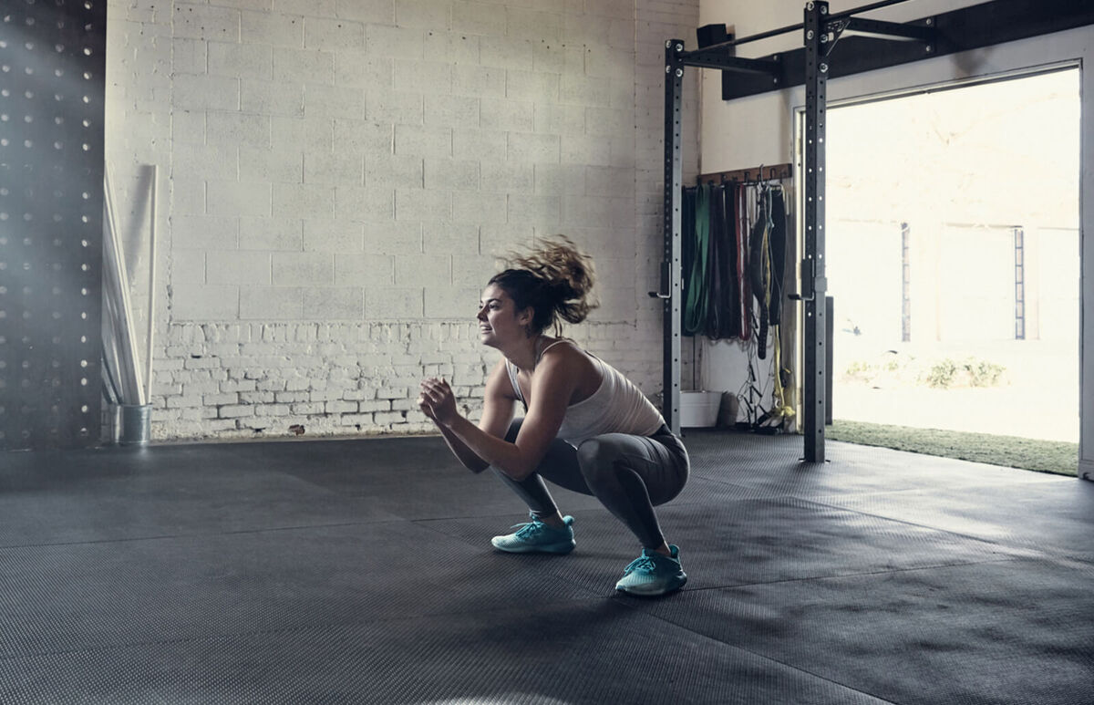 Woman in gym doing squats