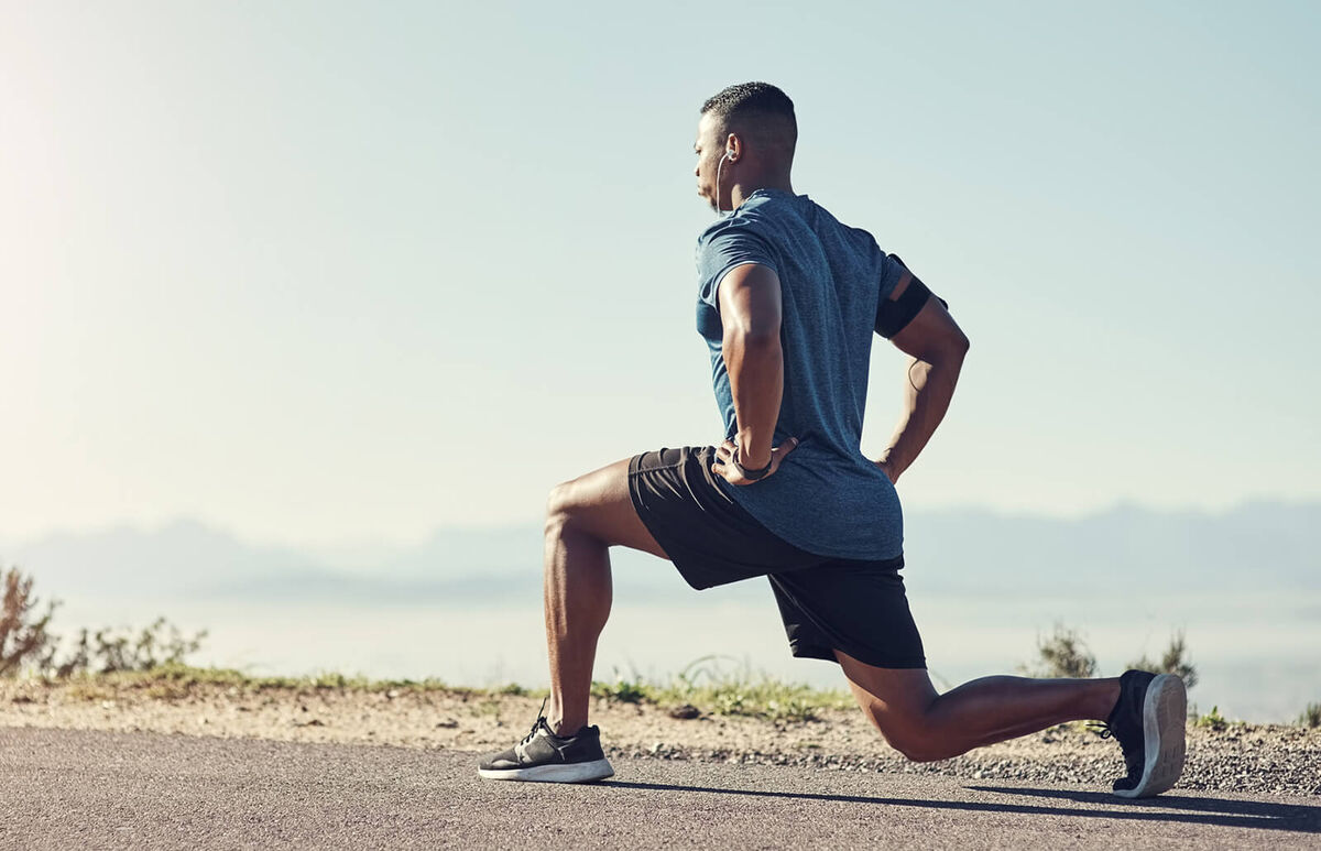 man doing lunges outdoors