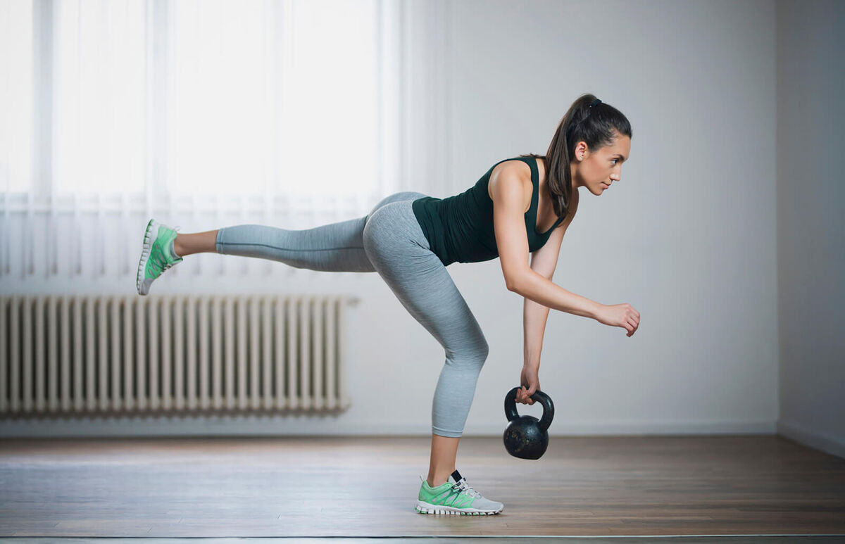 woman doing single-leg kettlebell deadlift