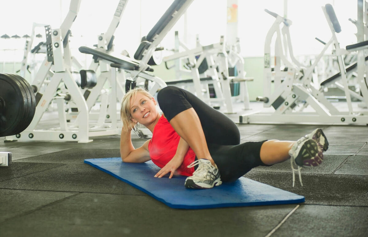 woman stretching in gymnasium