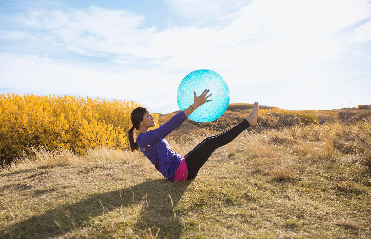 Woman balancing with fitness ball