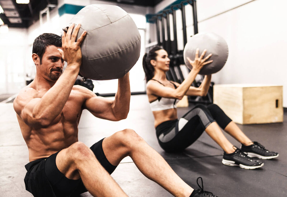 coach doing abs with the medicine ball