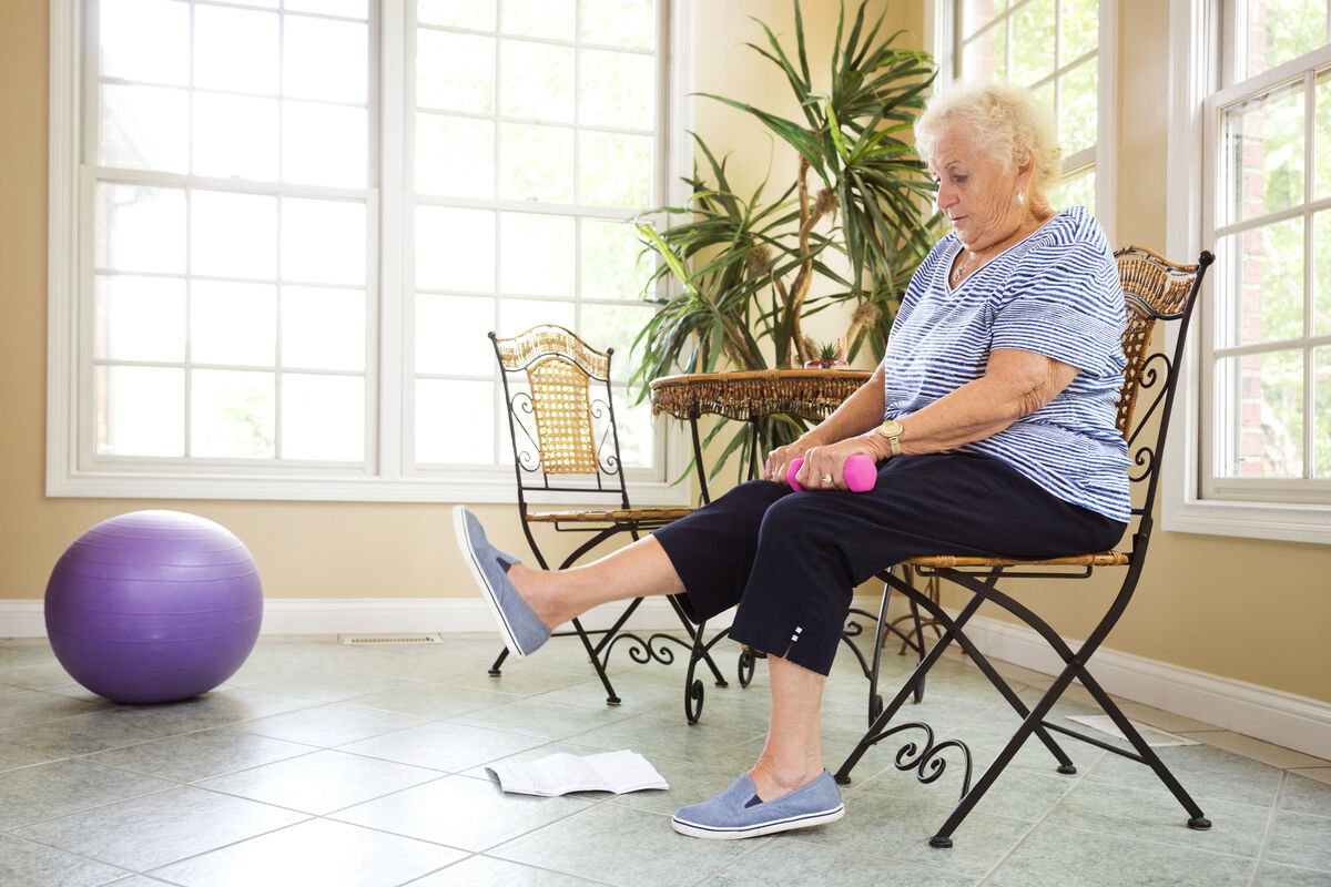 Senior exercising at home in a chair